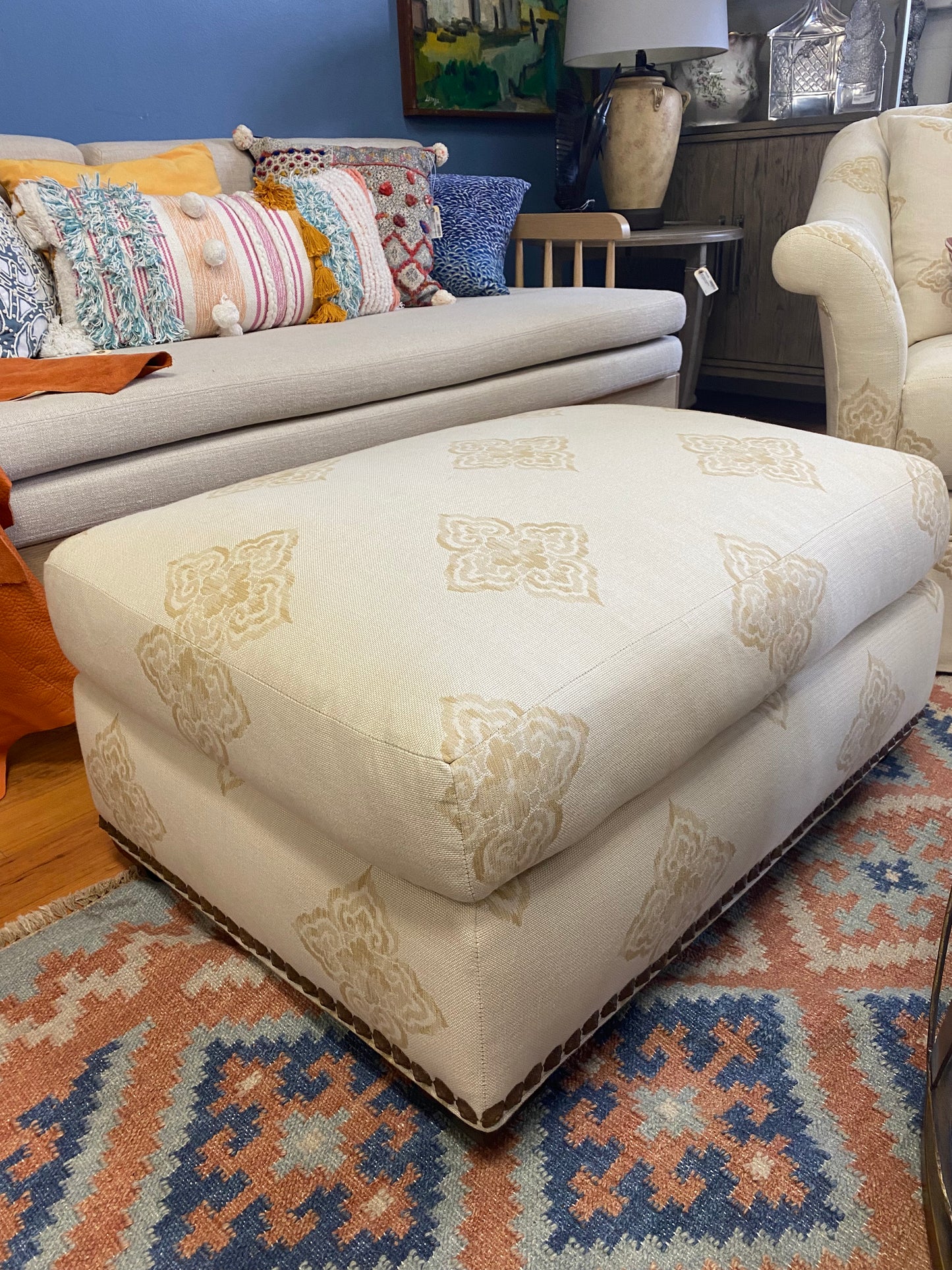 Pair of beige club chairs w/ottomans w/fleur de lis detail