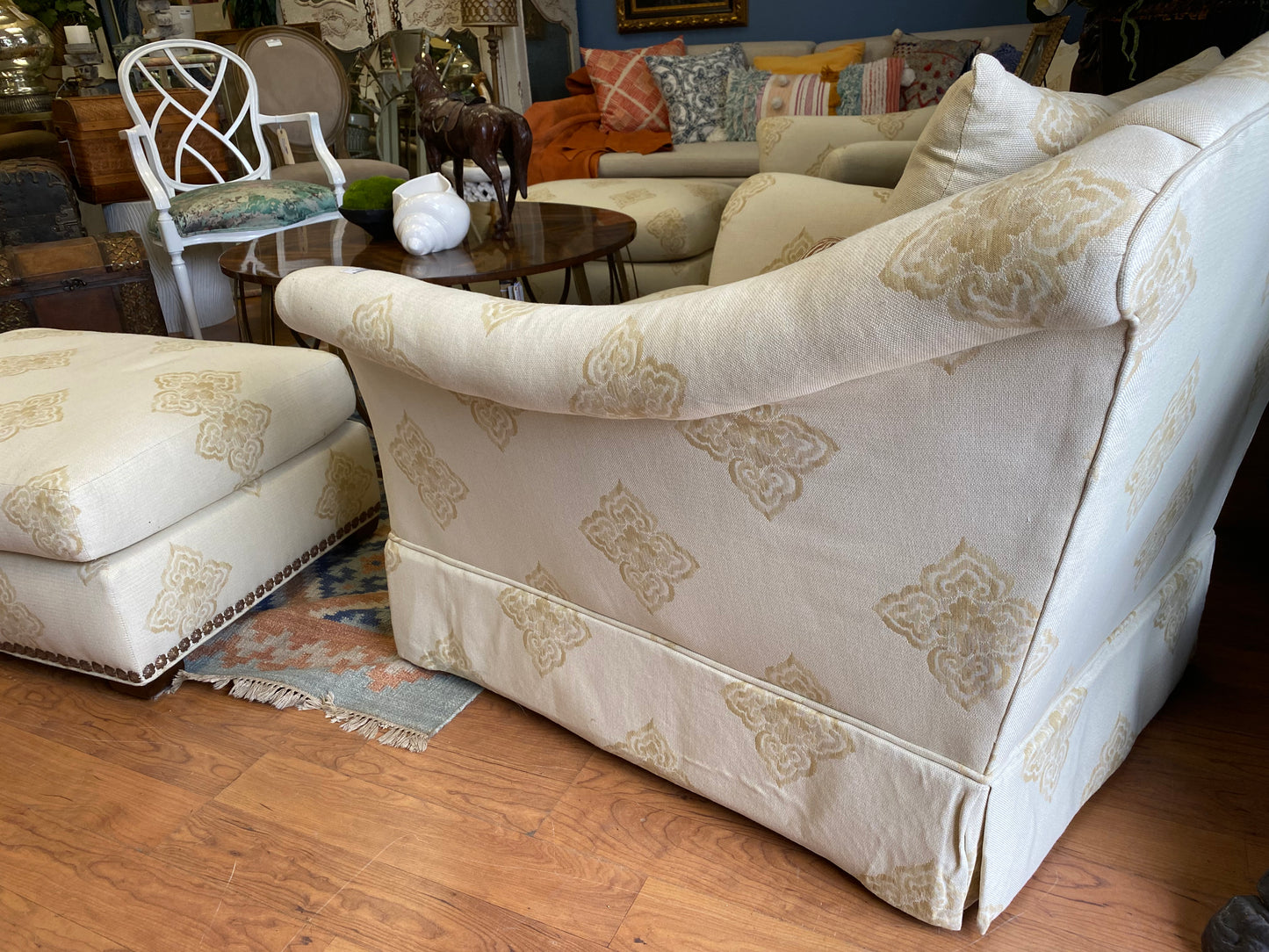 Pair of beige club chairs w/ottomans w/fleur de lis detail