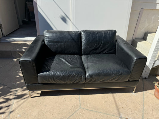 Black leather loveseat by Natuzzi